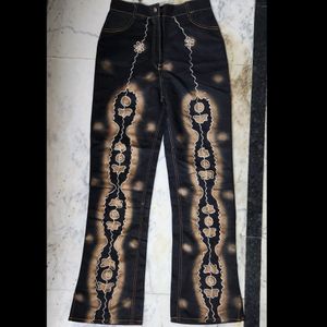 Black colur pant with golden embroidery all over the pant.