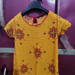 Yellow A Line Kurti With Flower Design In It