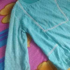 An Aqua Blue Top With Flared Sleeves