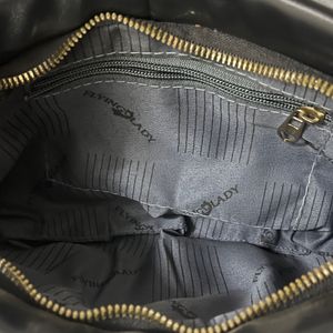 Black leather bag with gold chain strap