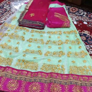 Net Lahenga With Net Dupatta And Raw Silk Blouse Piece