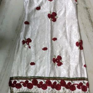 Elegant White Dress with Red Floral Embellishment