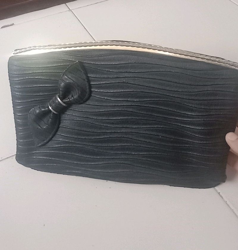 Black clutch bag with solid gold finish