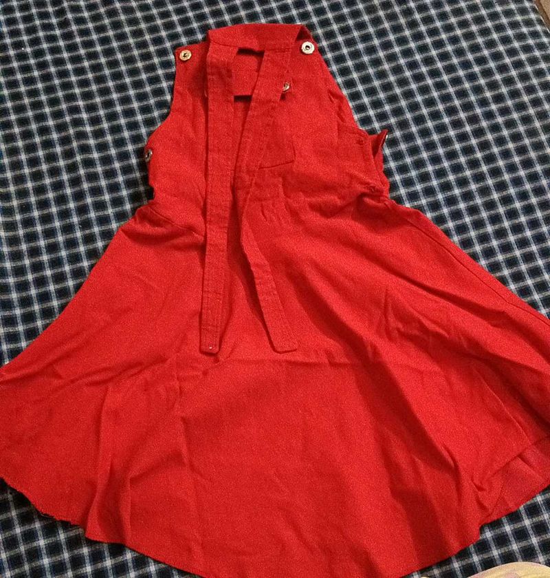 A Dungaree Dress In Bright Red