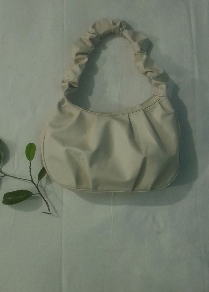 A Beige Side Bag.