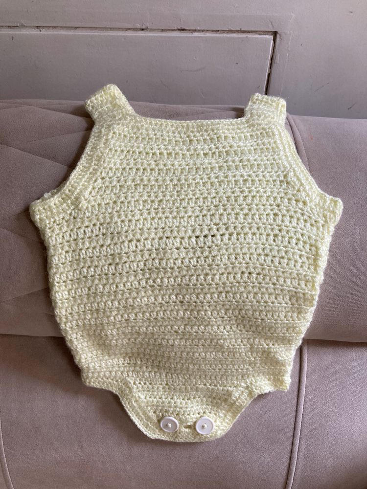 A Crochet Set Of Romper, Bonnet And Booties