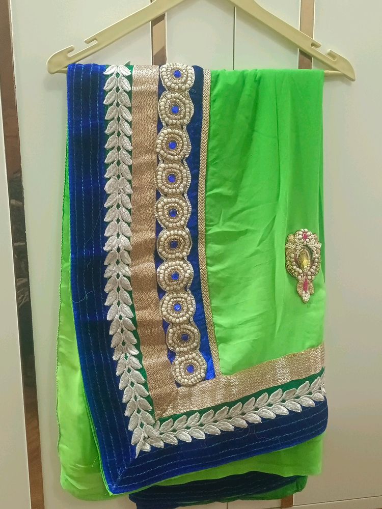 A Green Saree With Blue Border