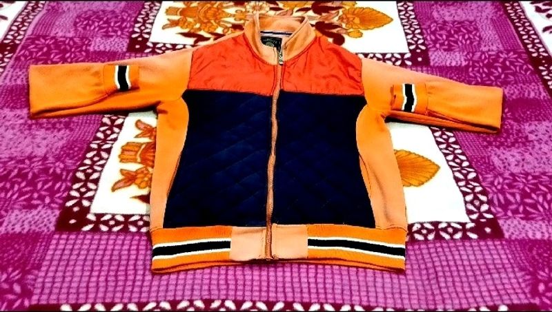 IT IS AN ORANGE COLOR JACKET....