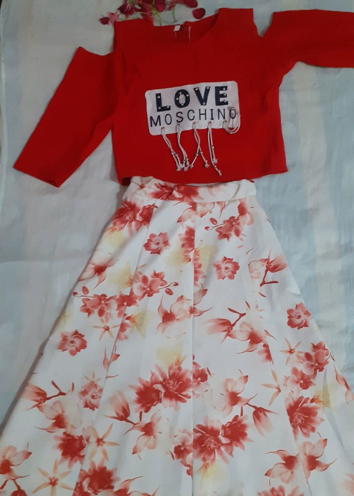 Red top with shoulder design and floral skirt