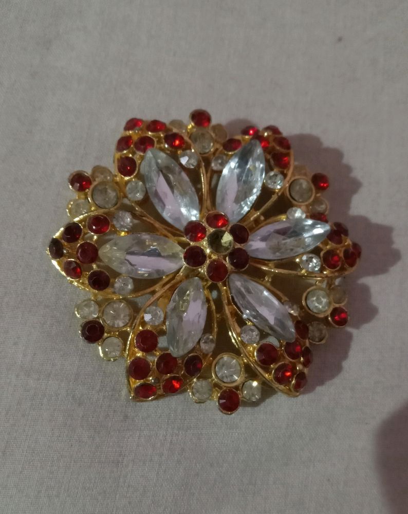 A Broach Of Metal With Diamonds