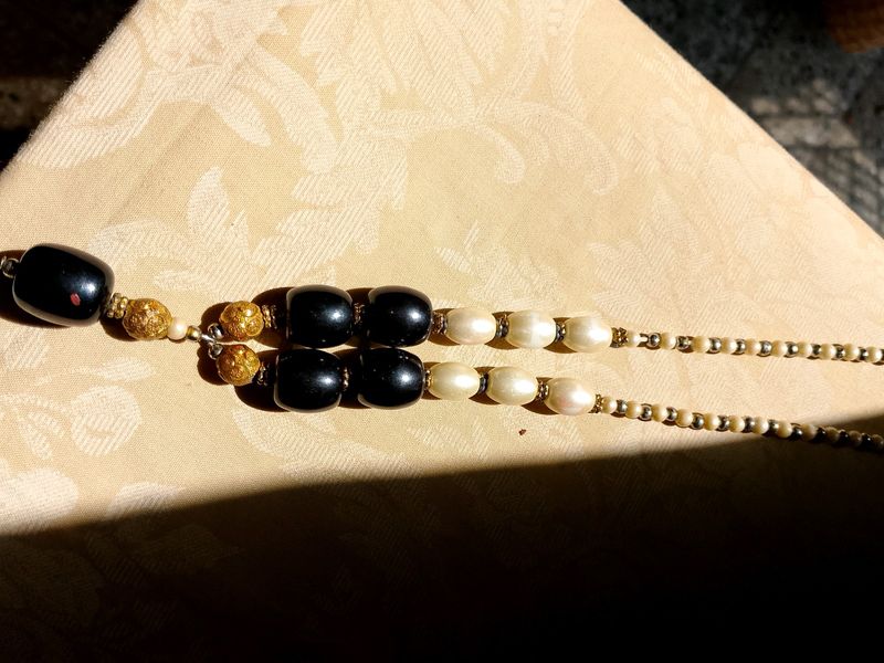 A Black nd White Pearl Necklace With Golden Work