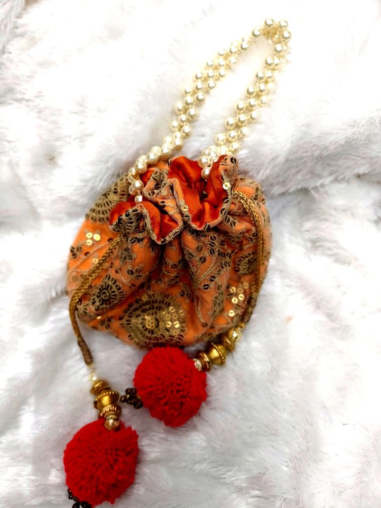 Radiant Elegance: Orange & Golden Potli Bag