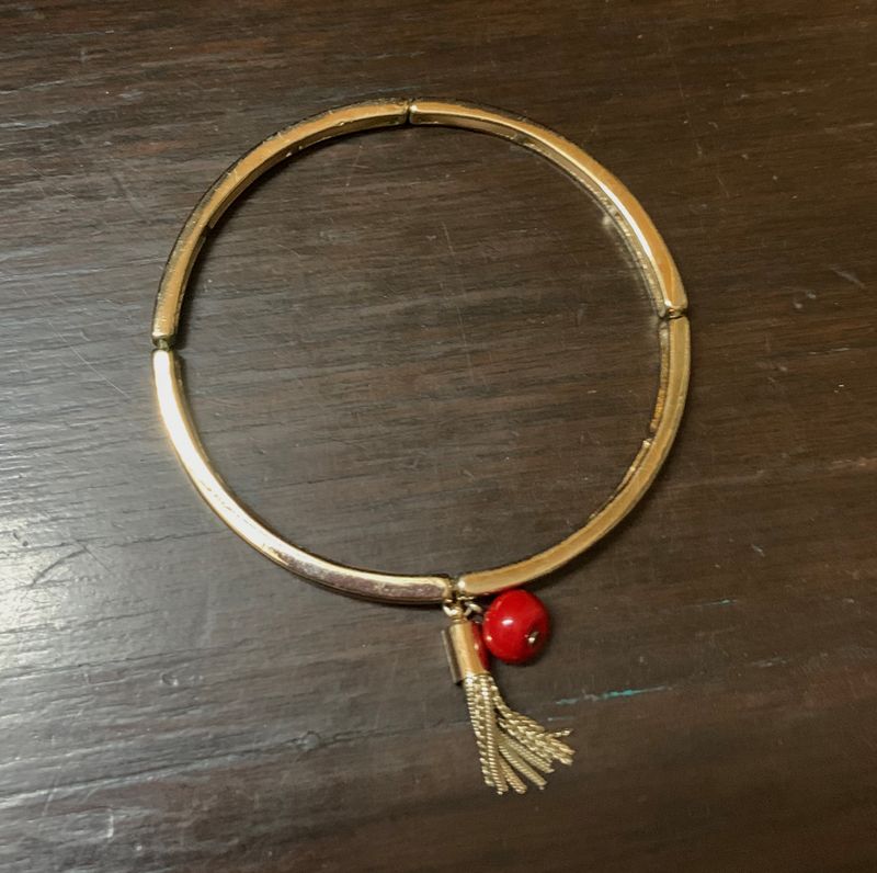 Elegant Metallic Bracelet With a Red Bead