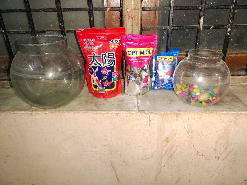 Two Fish Bowl And Three Packets Of Fish Food And Stones Also