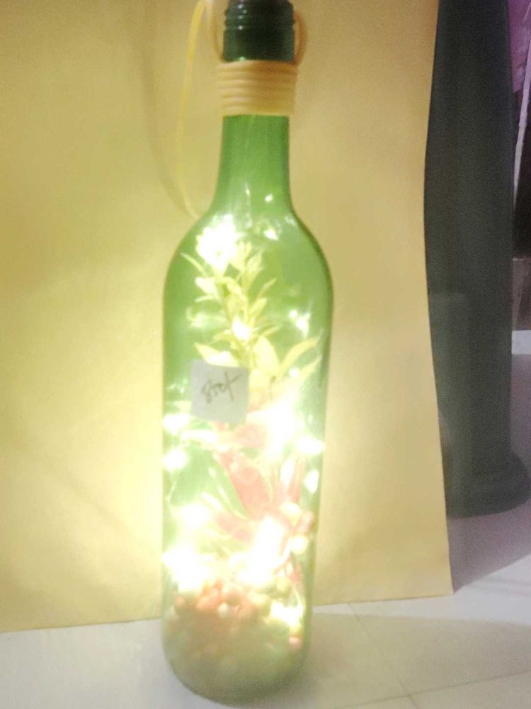 Bottle Lights With Flowers And Decorative Pieces