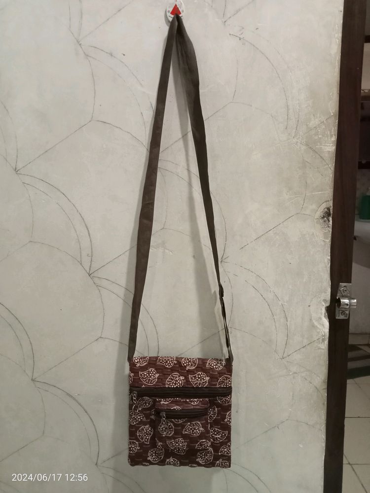 Brown Colour Sling bag. It Has 3 Sections.