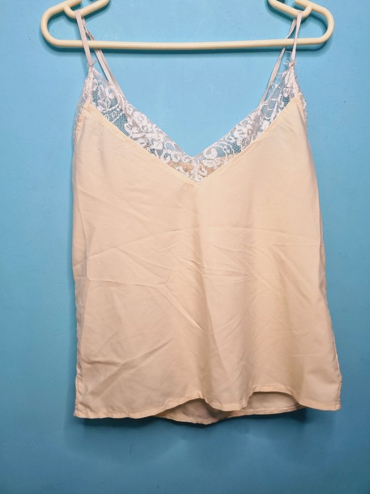 Cream Cami Top With Net Design On Neck.