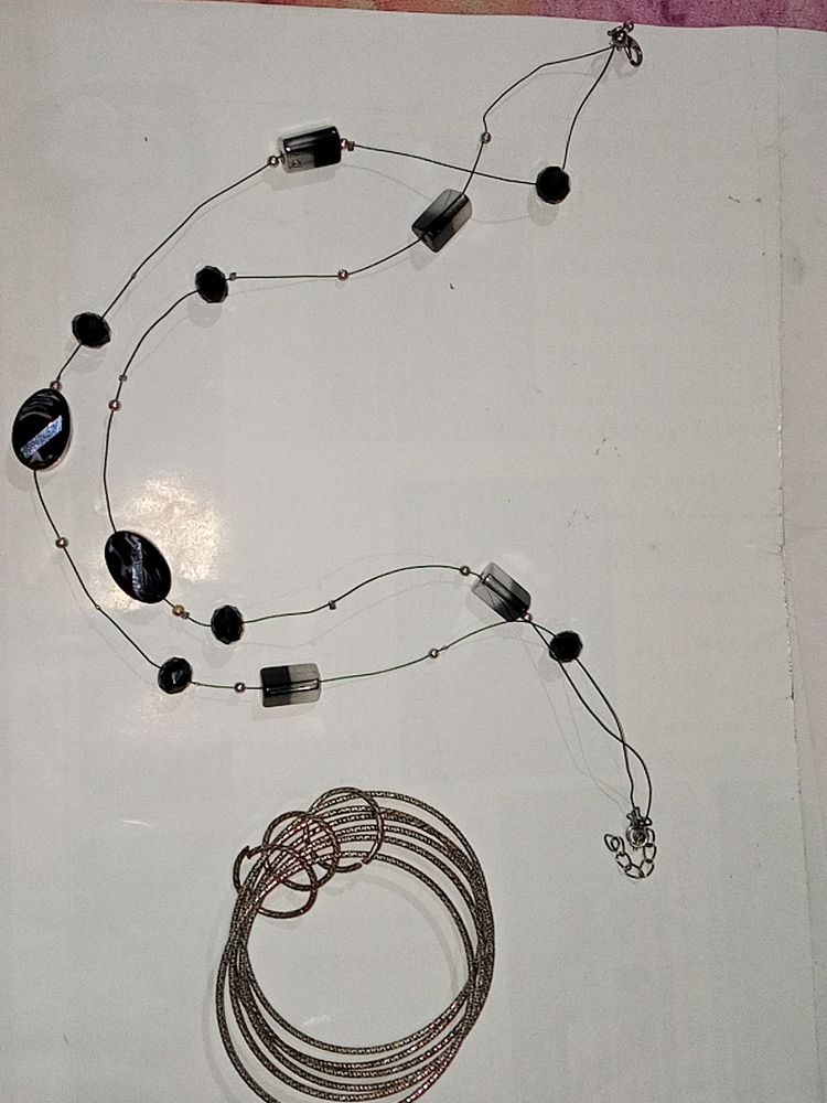 A Semi Black Neckpeice With Churi Bracelet.