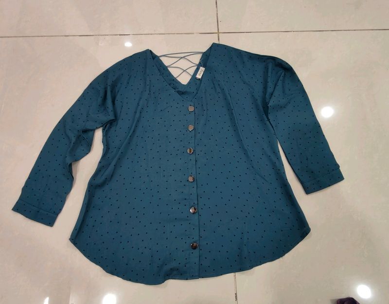 Blue Top With Black Buttons And Design On Back.