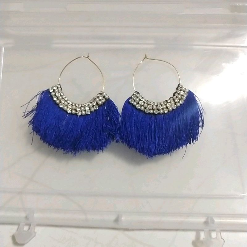 medium sized ear rings with blue threads