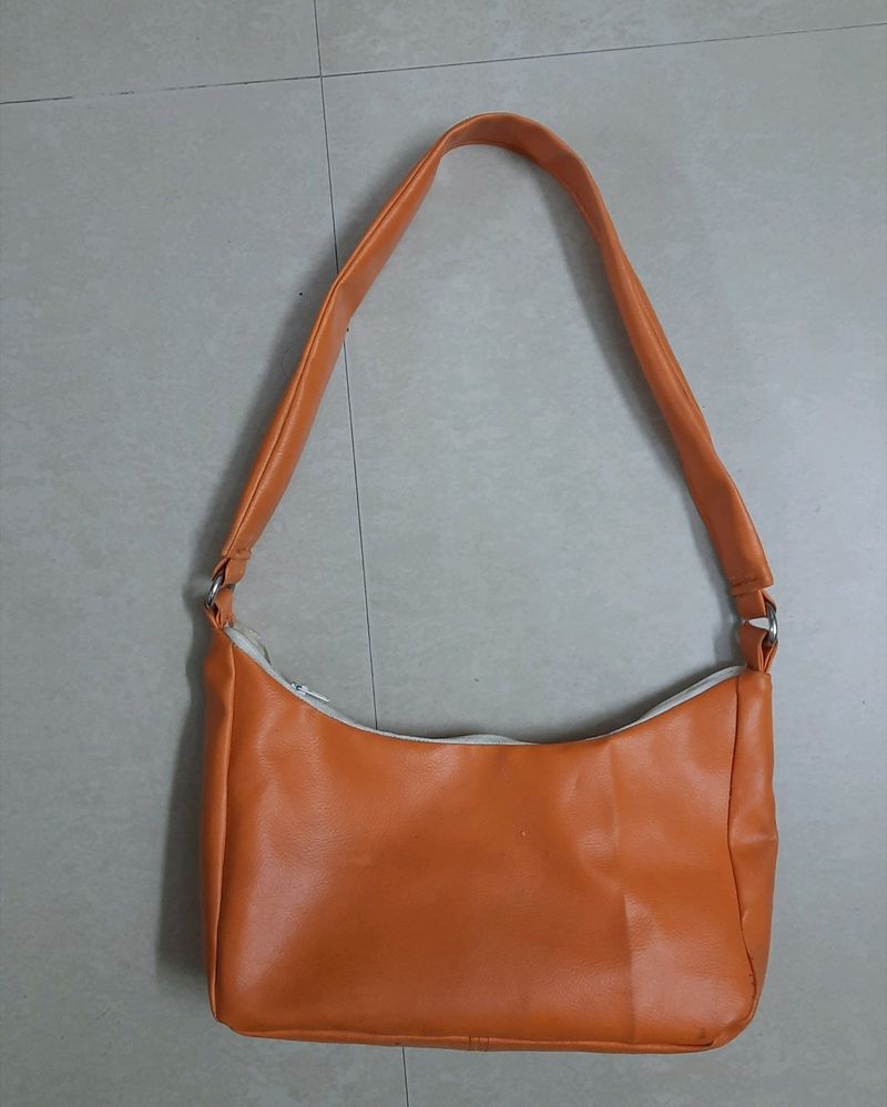 Orange shoulder baguette bag