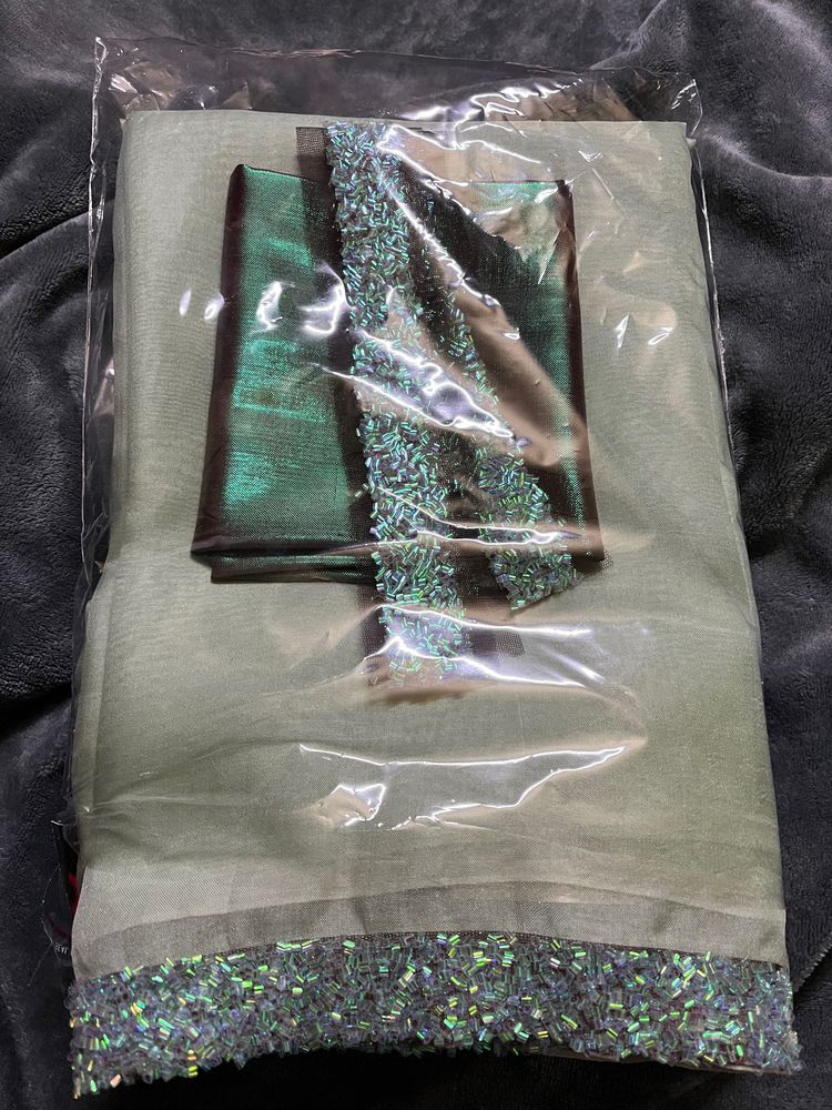 Pista green organza silk saree & contrast metallic