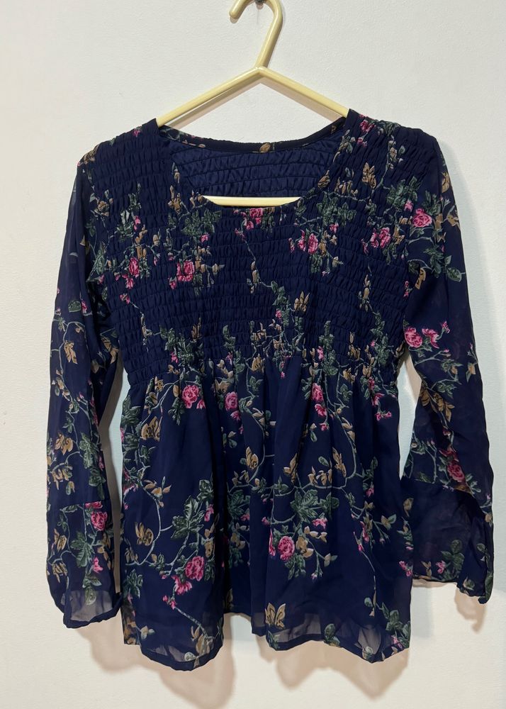 This is a navy blue long-sleeved blouse