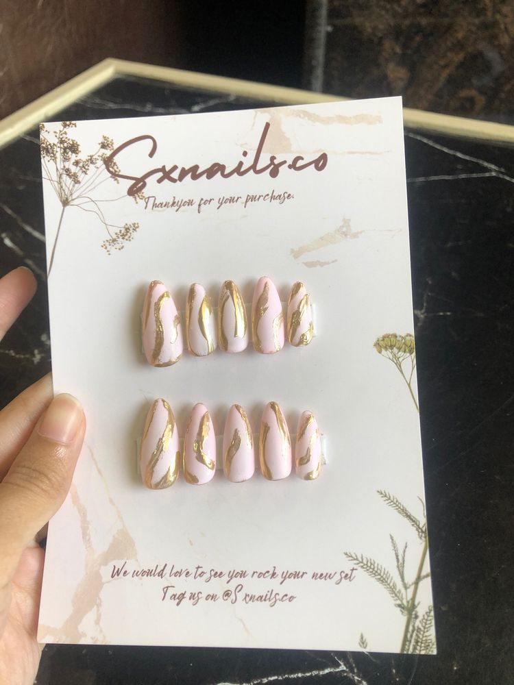 Pink presson nails with gold metallic strips