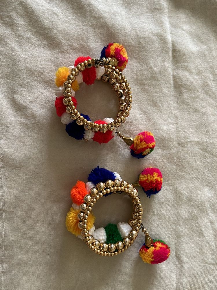 golden bracelets with pompom