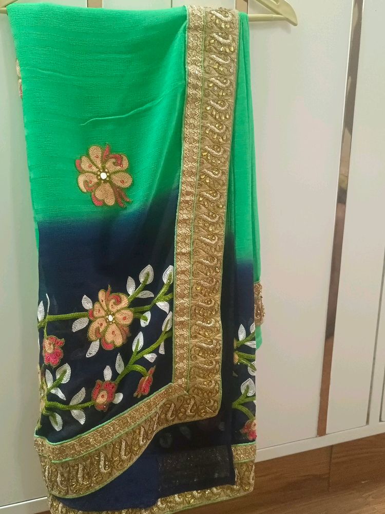 A Green Saree With Navy Blue Border