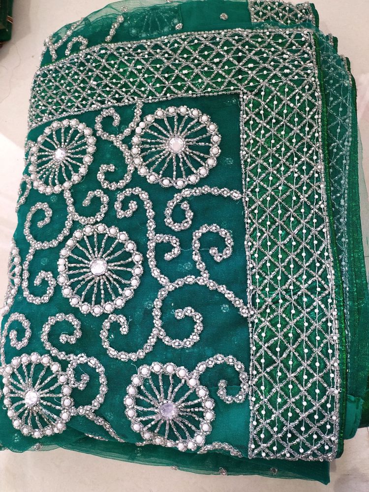 bottle green net saree with blouse and lehnga