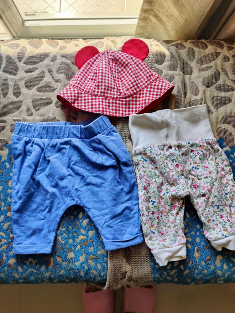 Mothercare joggers (set of 2) and a baby cap.