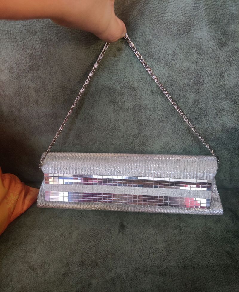 Silver Clutch. There are very few stains over it i