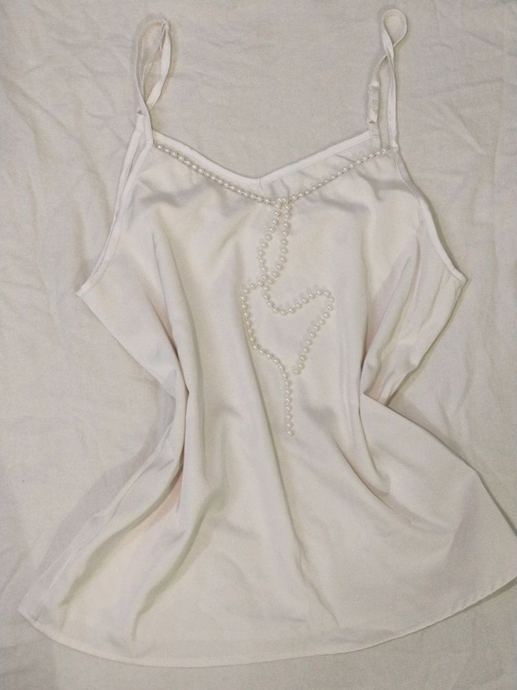 White top with pearl detail