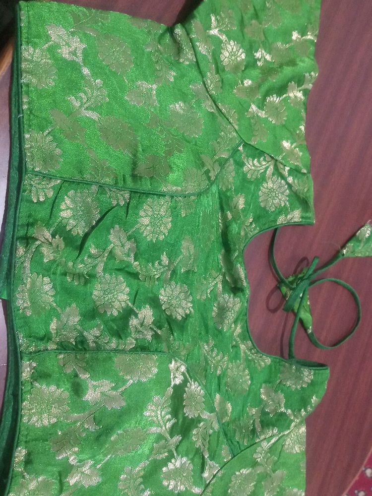 Green colour soft brocade padded blouse . It has princess cut in the front ruffles on sleeves