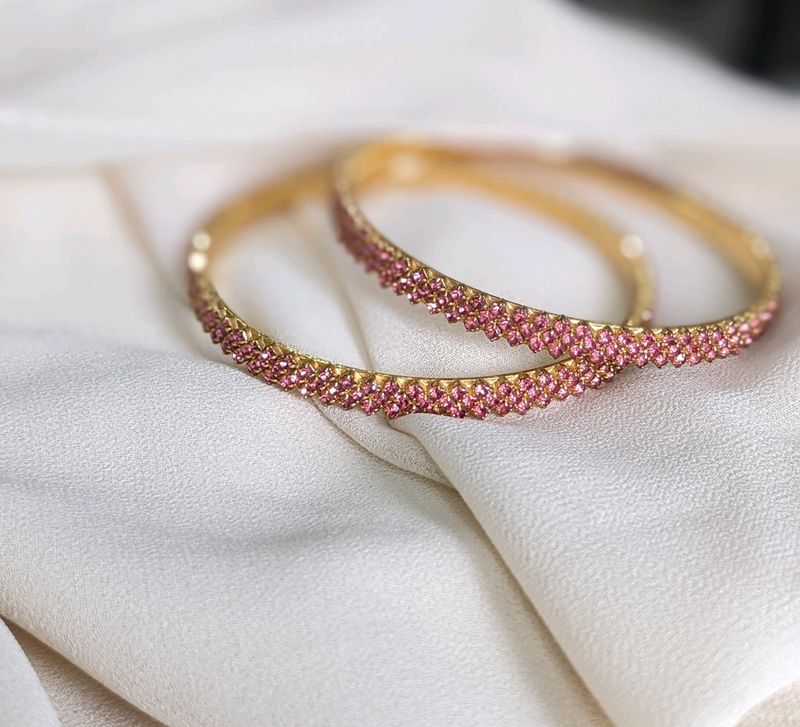 A Rose Gold Bangle With Ros Stones